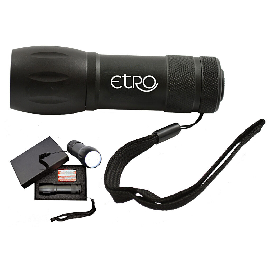 Black aluminum nine-LED flashlight with etro sample logo, wrist strap and an inset showing the gift box.